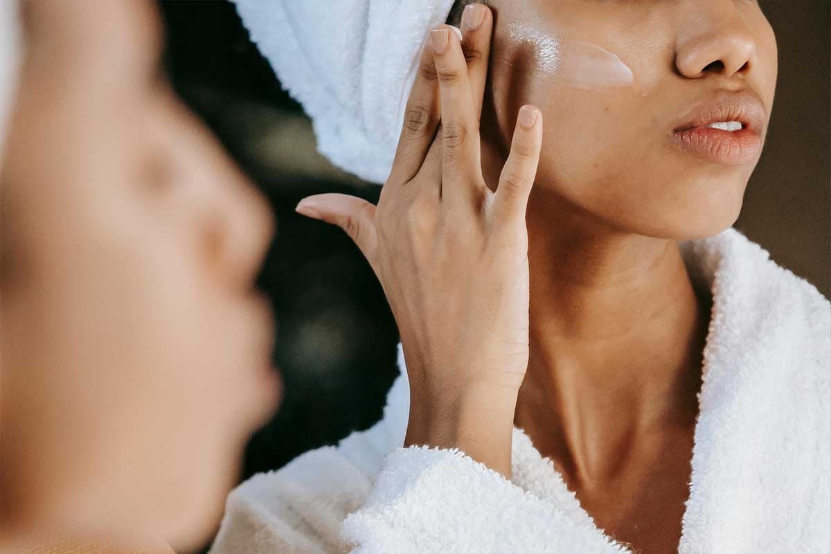 Woman applying face cream