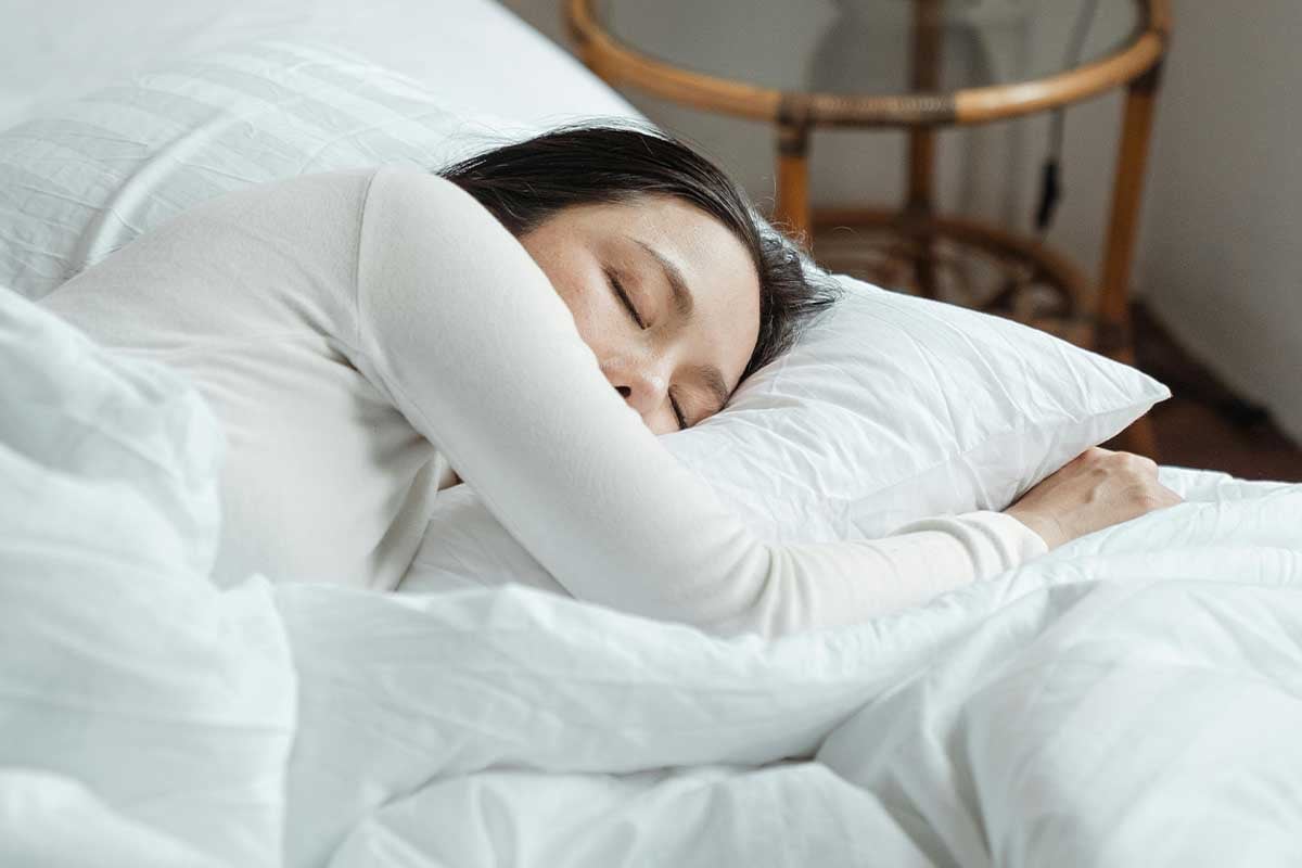 Woman sleeping in a comfy bed