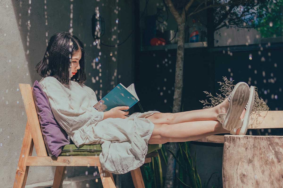 Woman reading a book outside